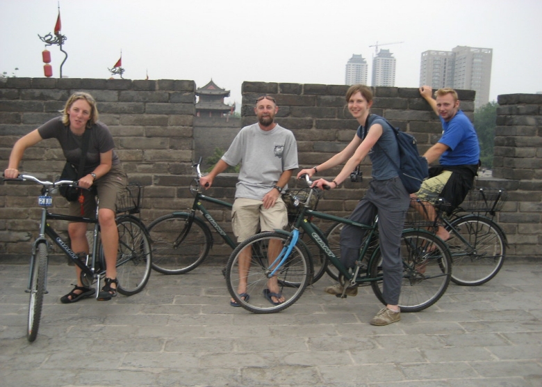 Cyclists enjoying a leisurely ride along the wide, well-maintained surface of the Xian City Wall