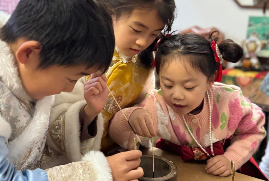 The children were engrossed in the fun of fighting crickets