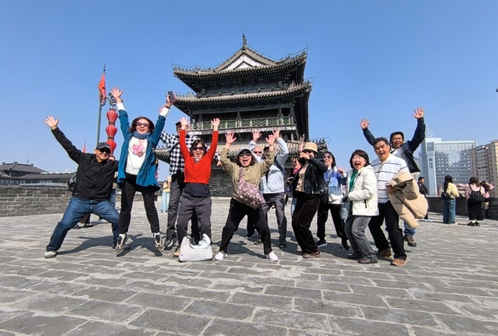 Guests pose for a group photo on the city wall