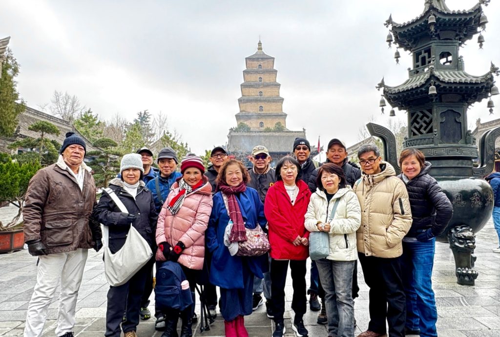 Guests pose for a group photo in front of the Big Wild Goose Pagoda