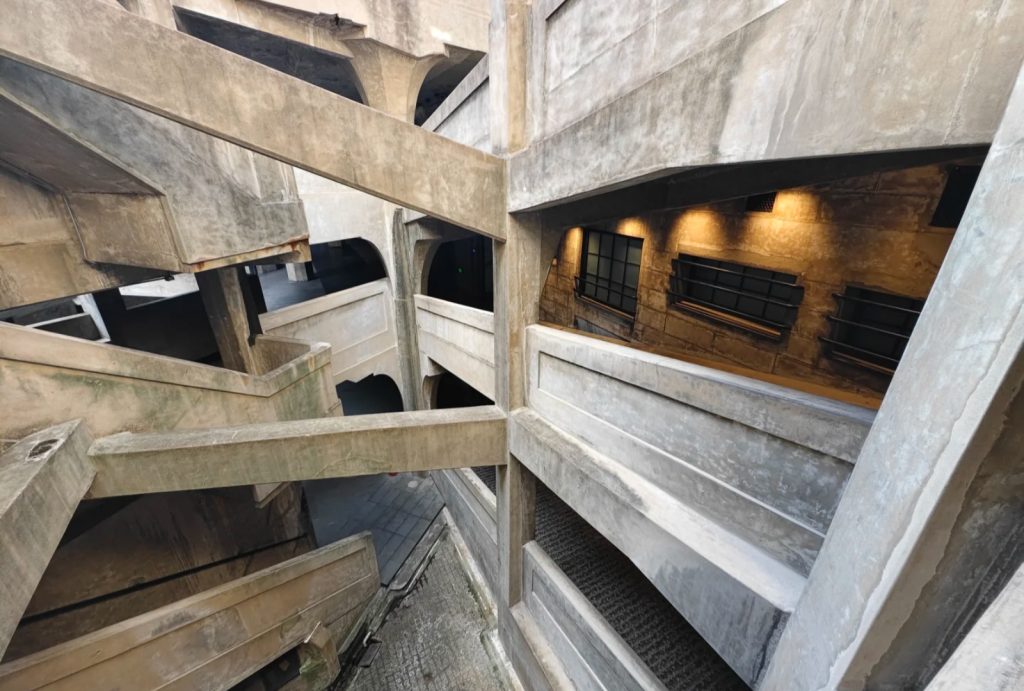 The distinctive interior of 1933 Old Millfun, featuring its striking concrete structure and geometric design.