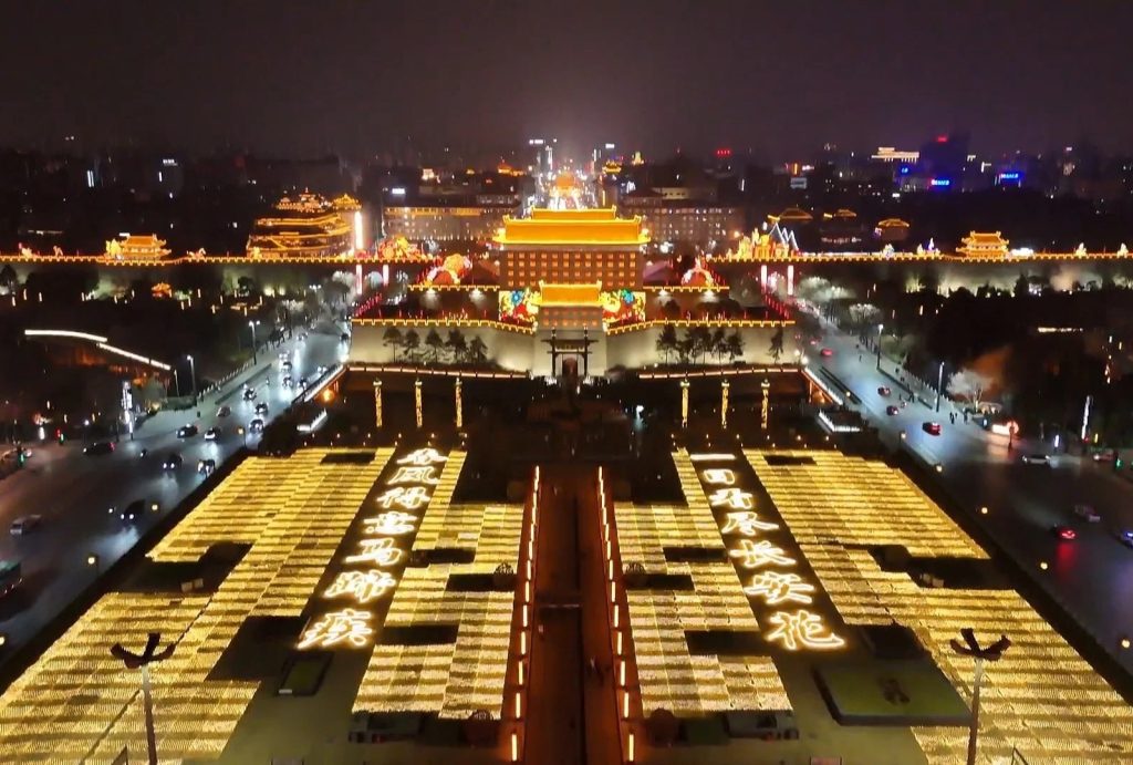Aerial night view of Yongning Gate square with Chinese poem light display