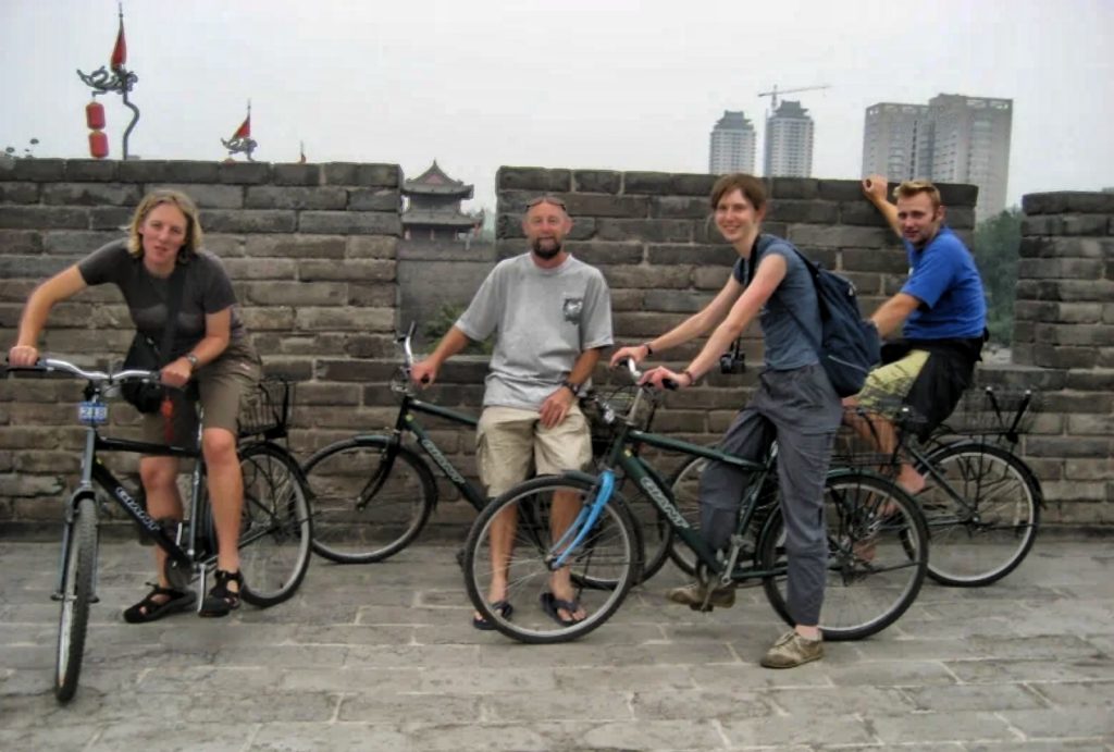 Cyclists enjoying a leisurely ride along the wide surface of the Xian City Wall