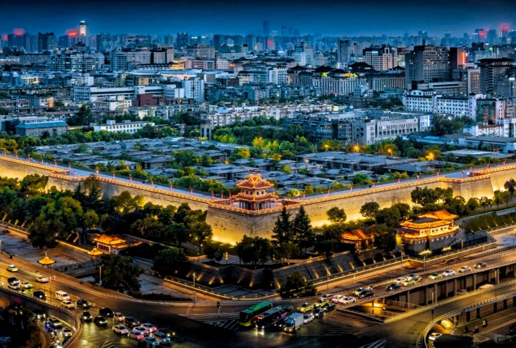 Illuminated Xi'an City Wall vs Modern Building at night