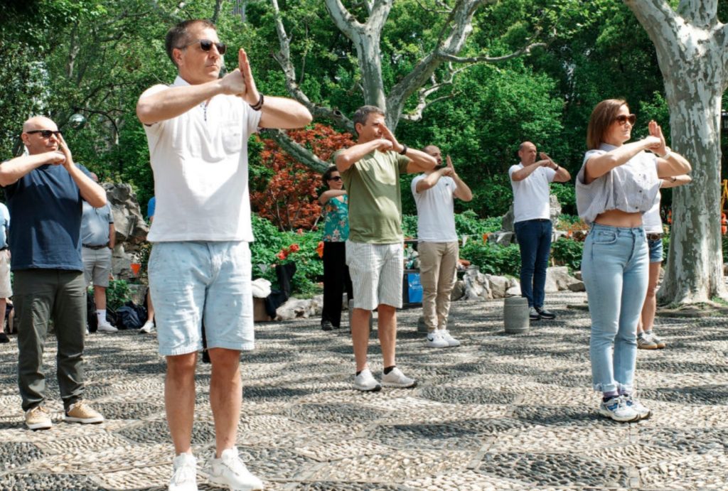 International travelers learning tai chi with locals at Shanghai’s Fuxing Park.