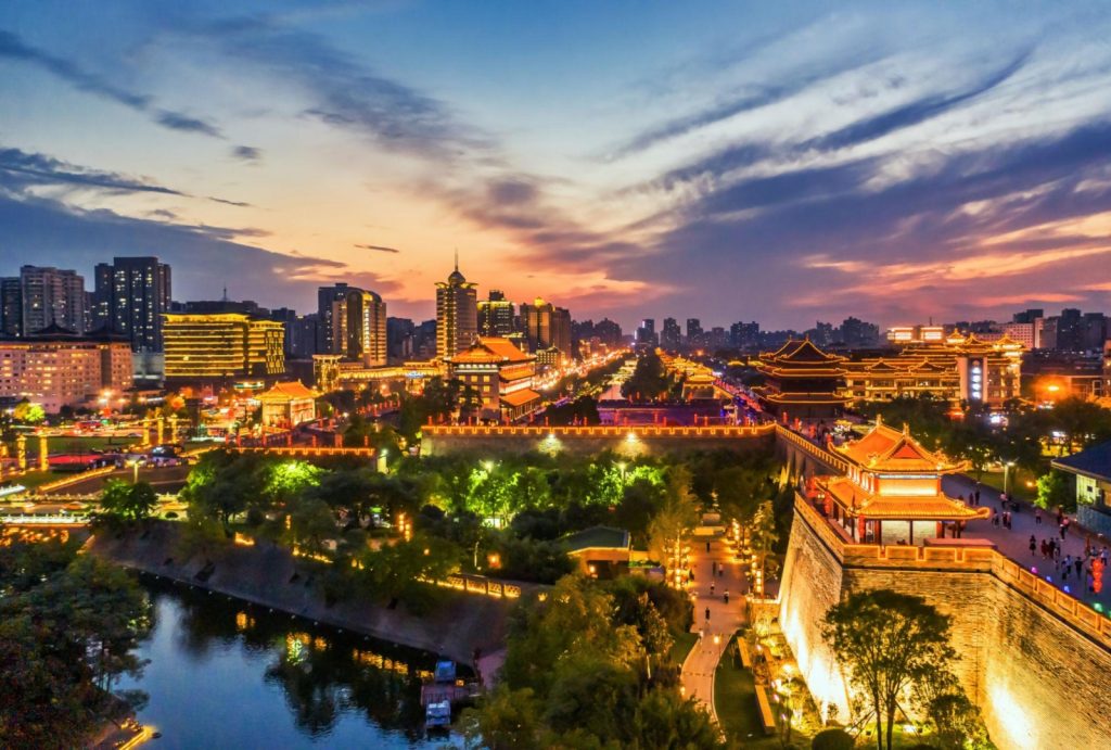 Twilight view of illuminated Xi'an City Wall and moat